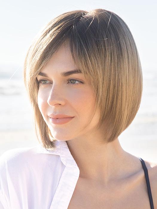 CODI by Amore in MACADAMIA-LR | The root is soft brown color that melts into a beige blonde color.